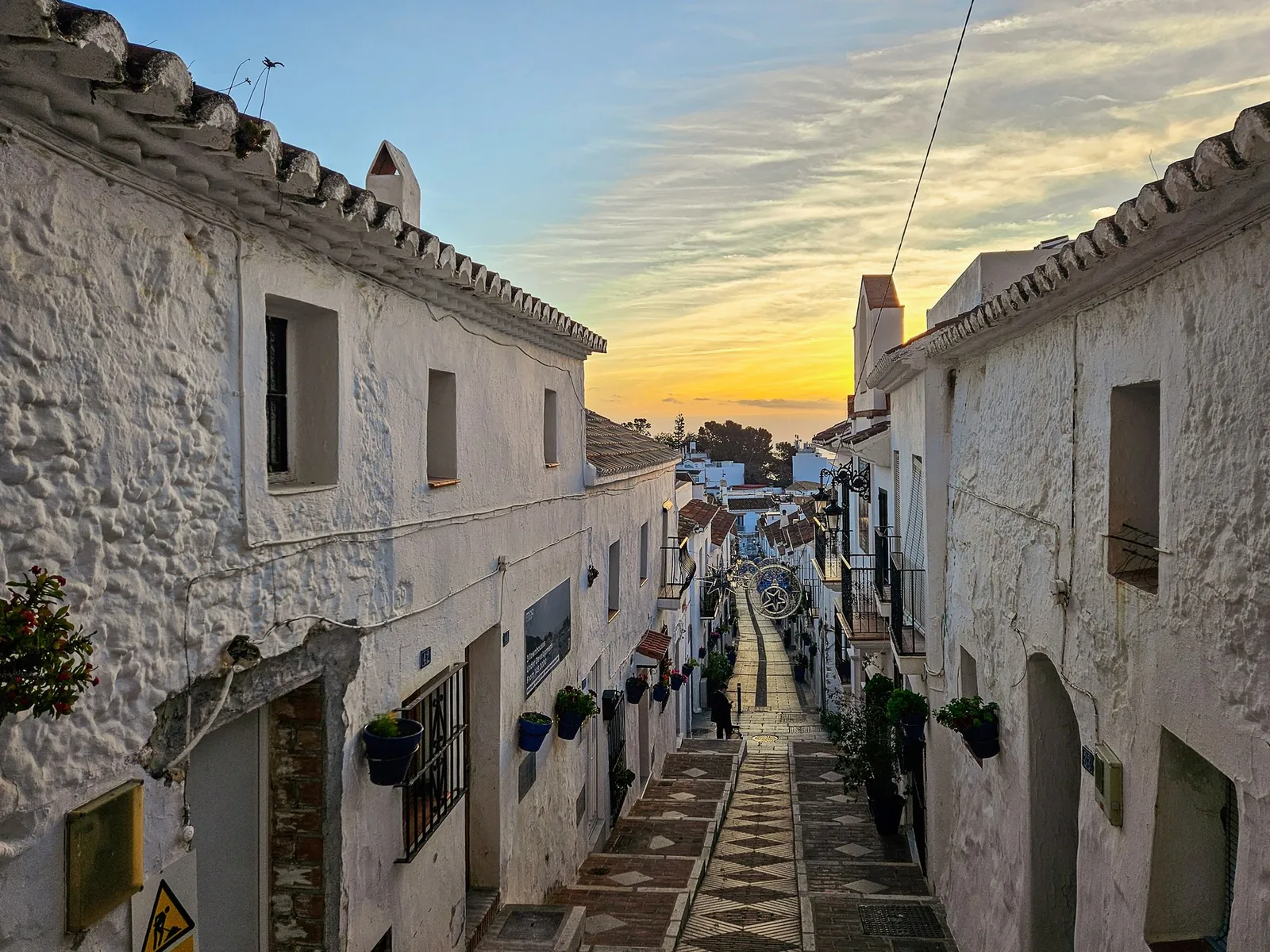 White buildings along Calle San Sebastian in Mijas Pueblo at sunrise